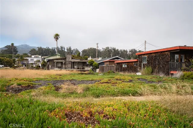 a view of a house with a yard and sitting area