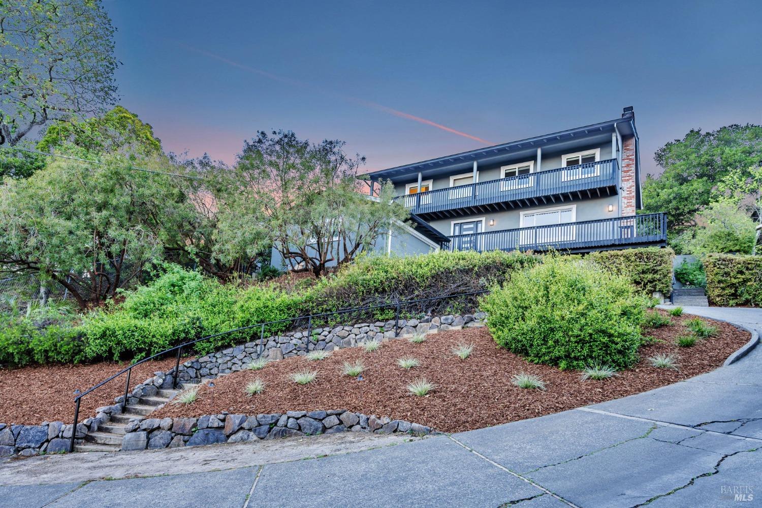 a backyard of a house with a yard and outdoor seating