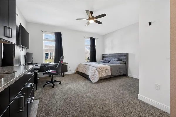 a bed sitting in a bedroom next to a window
