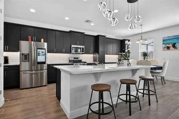 a view of a dining room with furniture and chandelier