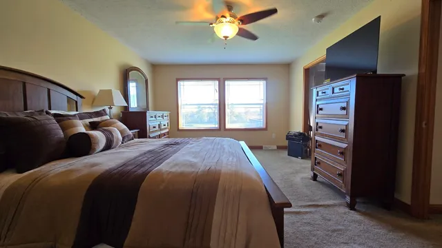 a bedroom with a bed and a television