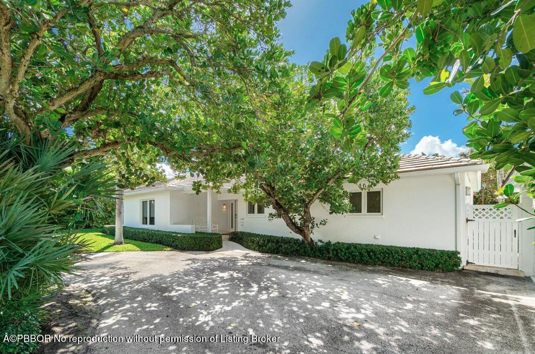 110 Seagate Road Palm Beach, FL 33480 - Photo 1 of 19 a view of a house with a small yard and large tree