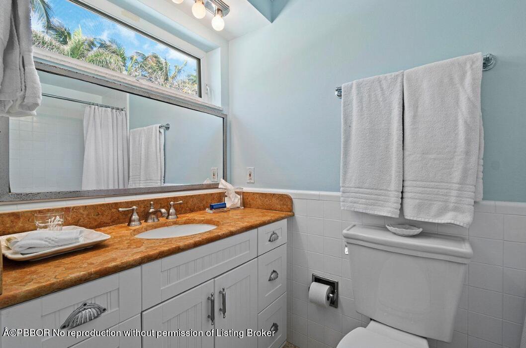 110 Seagate Road Palm Beach, FL 33480 - Photo 11 of 19 a bathroom with a granite countertop sink and a mirror