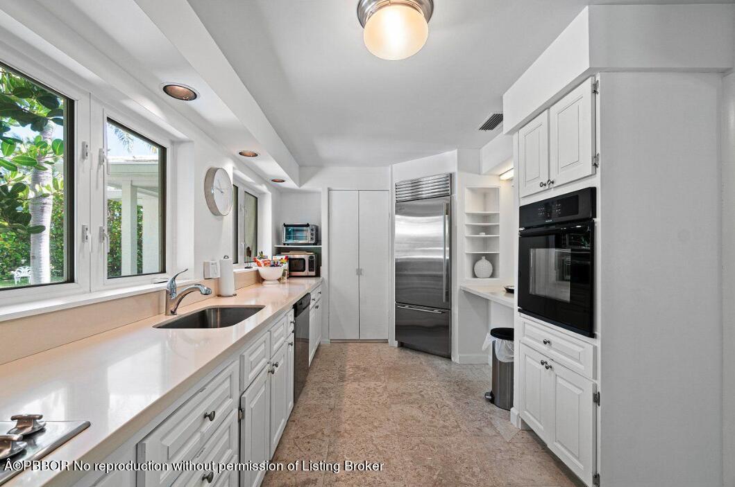 110 Seagate Road Palm Beach, FL 33480 - Photo 13 of 19 a kitchen with stainless steel appliances granite countertop a refrigerator and a sink