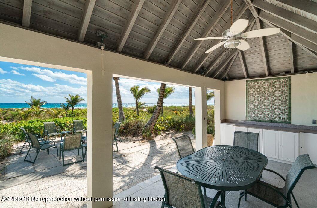 110 Seagate Road Palm Beach, FL 33480 - Photo 17 of 19 a dining room with furniture and a floor to ceiling window