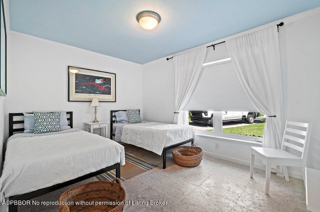 110 Seagate Road Palm Beach, FL 33480 - Photo 5 of 19 a bedroom with a bed and a table