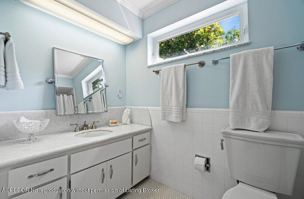 110 Seagate Road Palm Beach, FL 33480 - Photo 6 of 19 a bathroom with a sink and mirror with toilet