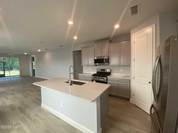 a kitchen with stainless steel appliances a refrigerator sink and stove