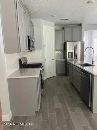 a kitchen with a refrigerator and a sink