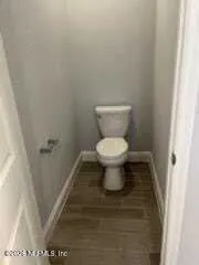 a bathroom with a toilet and a mirror