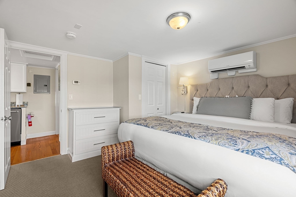 175 Bridge Road Salisbury, MA 01952 - Photo 21 of 42 a bedroom with a bed and a chandelier