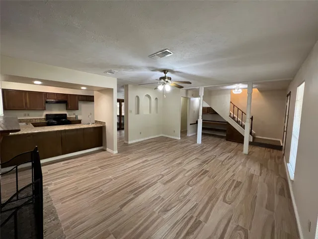 a view of a kitchen with a sink and a refrigerator