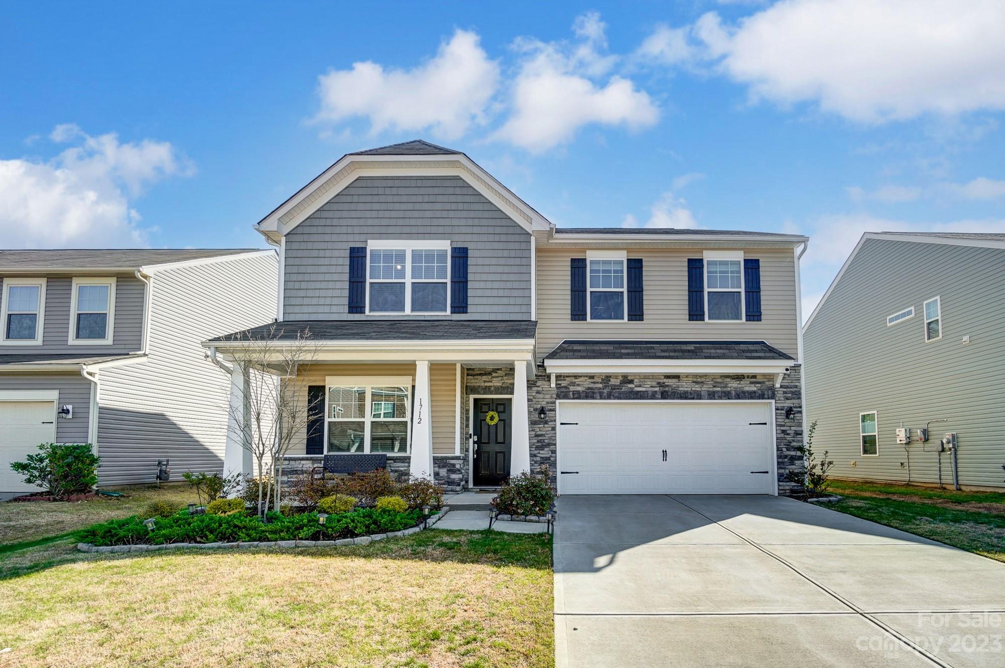 a front view of a house with garden