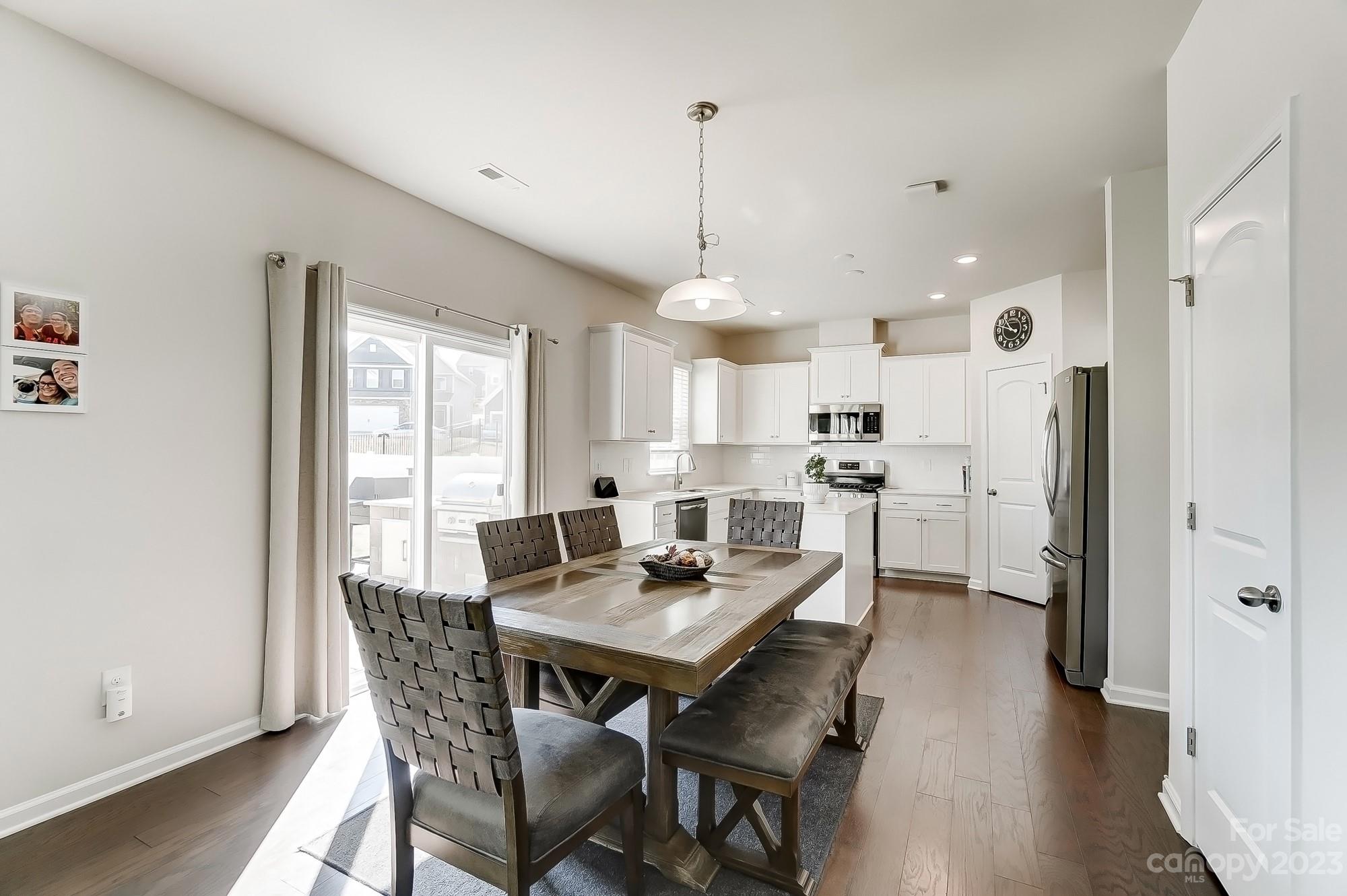 1712 Loggerhead Drive Lancaster, SC 29720 - Photo 12 of 43 a kitchen with a dining table chairs wooden floor and appliances