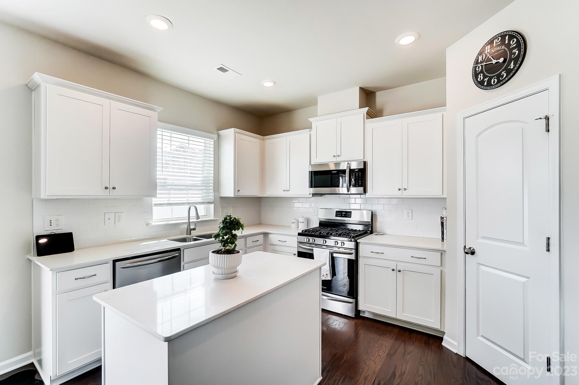 1712 Loggerhead Drive Lancaster, SC 29720 - Photo 6 of 43 a kitchen with a sink a stove cabinets and wooden floor