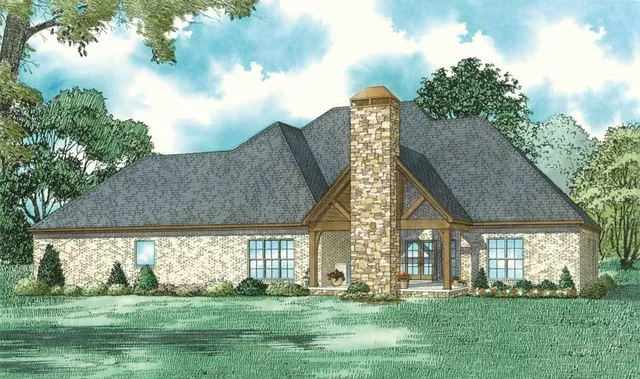 a view of a house next to a big yard and large trees