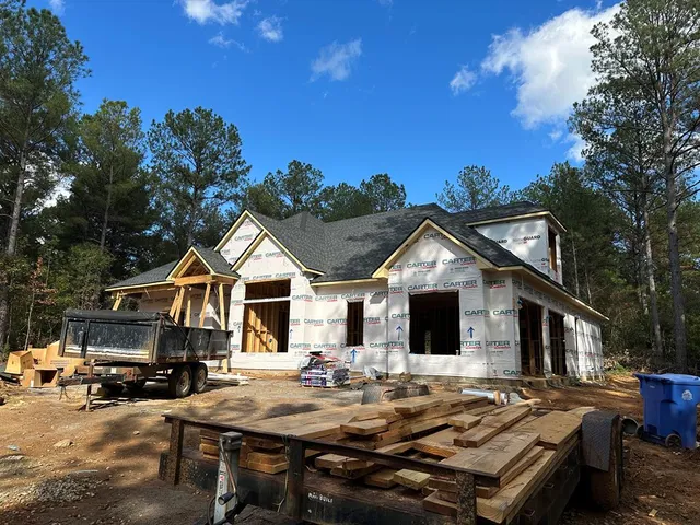 a view of house and patio with swimming pool and sitting area