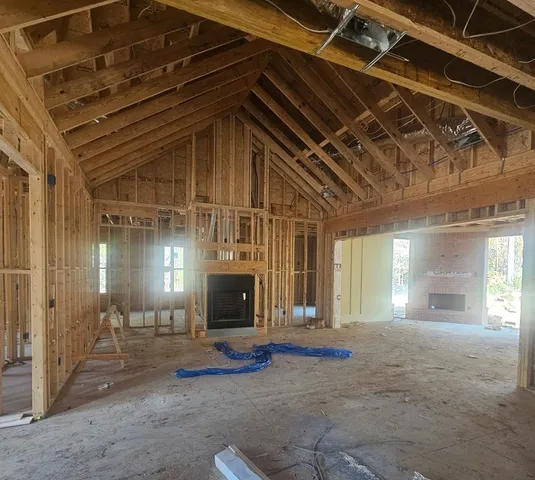 a view of a livingroom with fireplace and window