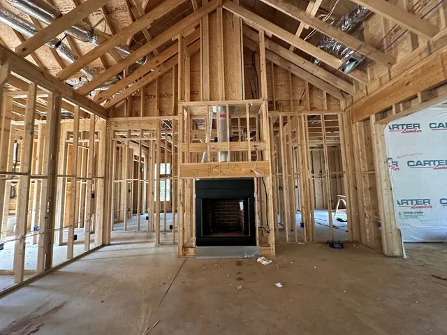 a view of a livingroom with an empty space and a fireplace