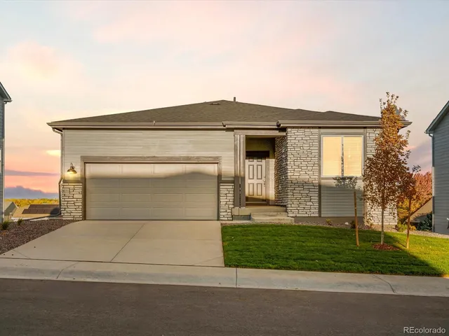 a front view of a house with garage