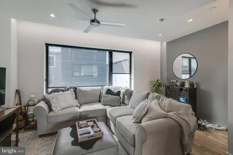 a living room with furniture a window and a chandelier