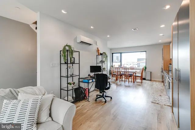 a view of a livingroom with workspace and a window