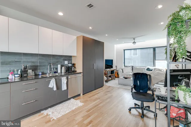 a kitchen with stainless steel appliances granite countertop a refrigerator sink and cabinets