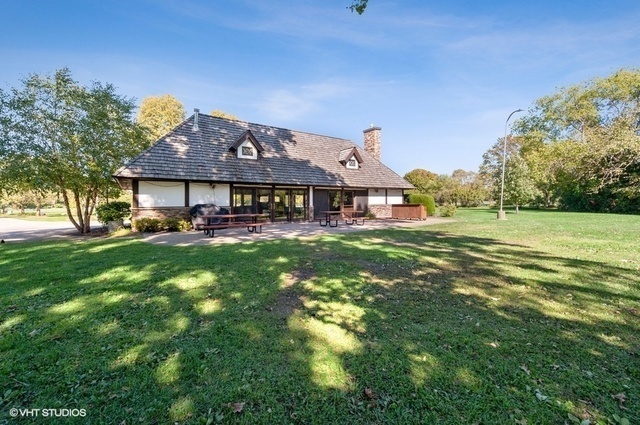 20 Marryat Road Trout Valley, IL 60013 - Photo 28 of 33 a front view of a house with a yard table and chairs