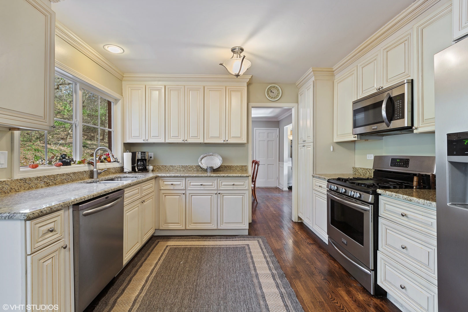 20 Marryat Road Trout Valley, IL 60013 - Photo 4 of 33 a kitchen with stainless steel appliances granite countertop a stove top oven a sink dishwasher a refrigerator and a microwave oven with wooden floor
