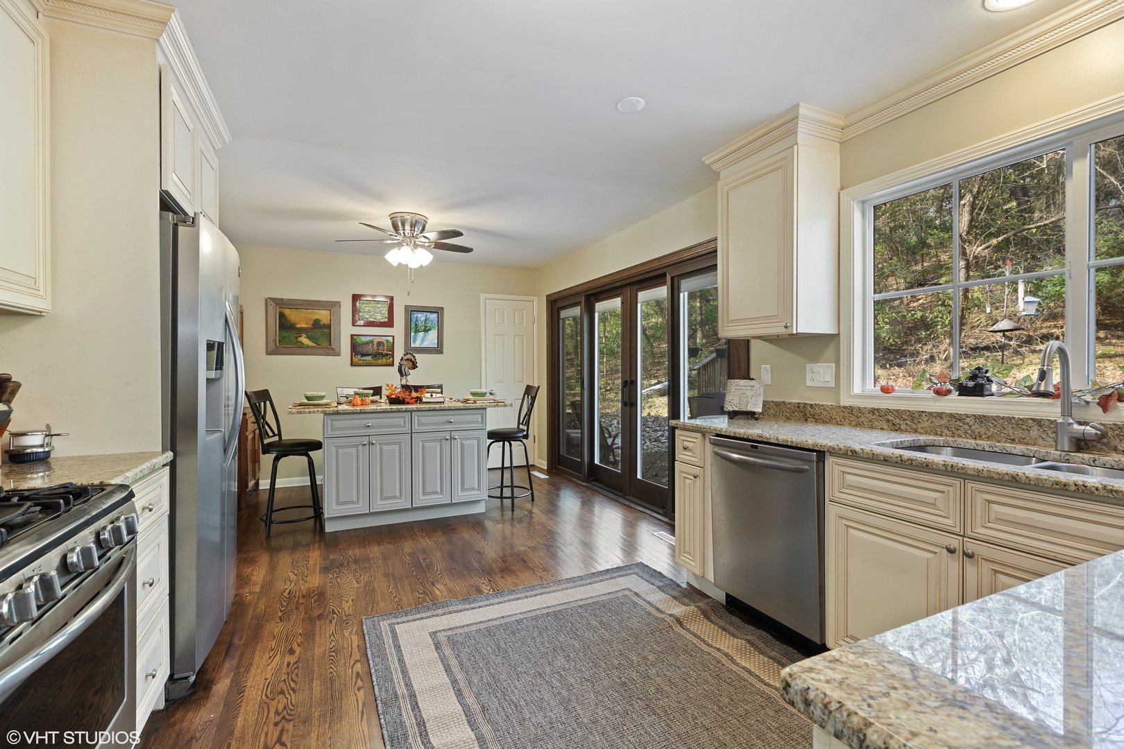 20 Marryat Road Trout Valley, IL 60013 - Photo 5 of 33 a kitchen with stainless steel appliances granite countertop a stove a sink dishwasher a refrigerator and white cabinets with wooden floor