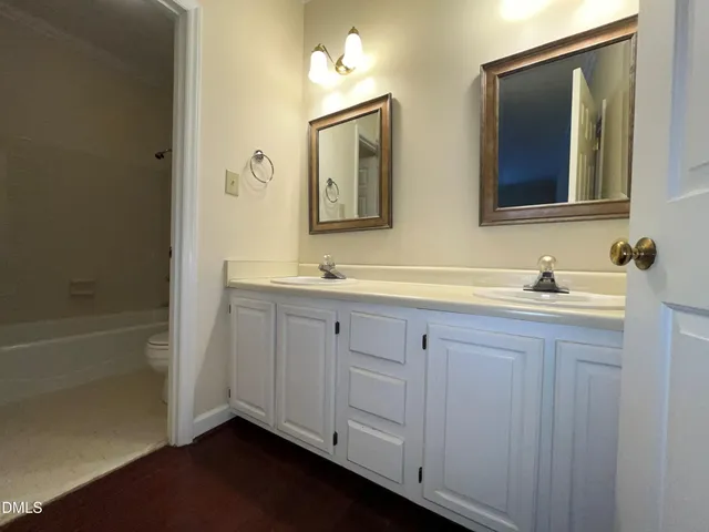 a bathroom with 2 sink tub and a mirror