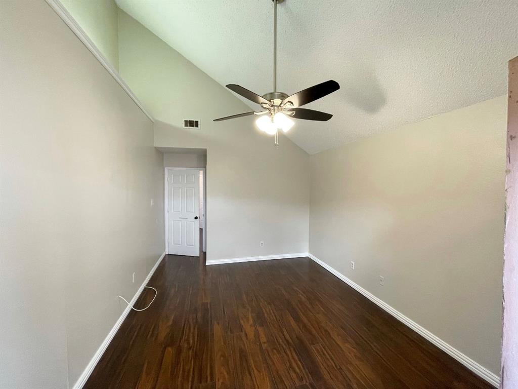 3147 Royal Gable Drive Dallas, TX 75229 - Photo 14 of 22 a view of a room with wooden floor a ceiling fan and a window