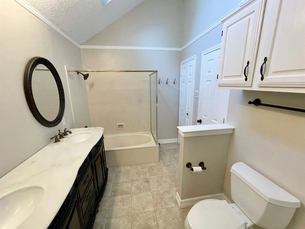 3147 Royal Gable Drive Dallas, TX 75229 - Photo 15 of 22 a bathroom with a granite countertop toilet a sink and a bathtub