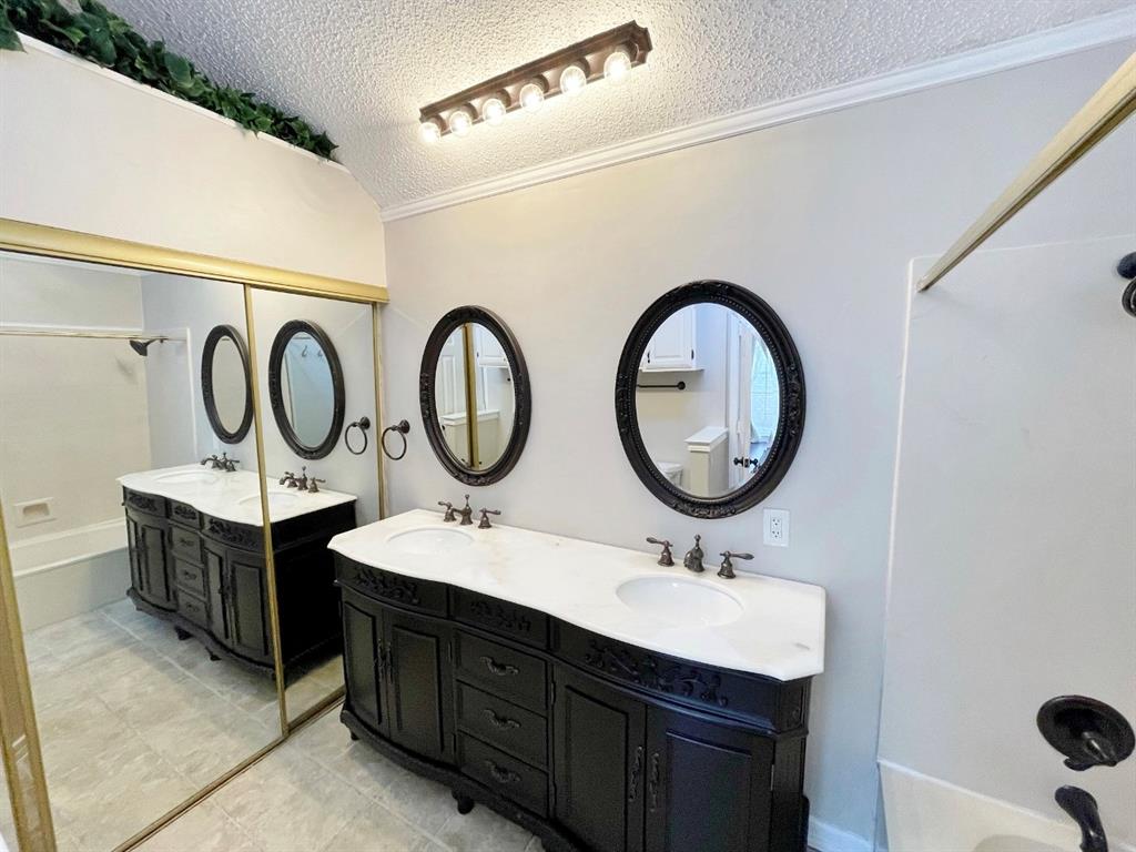 3147 Royal Gable Drive Dallas, TX 75229 - Photo 16 of 22 a bathroom with a double vanity sink and a mirror