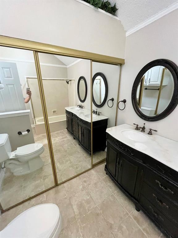 3147 Royal Gable Drive Dallas, TX 75229 - Photo 17 of 22 a bathroom with a toilet a sink and a mirror