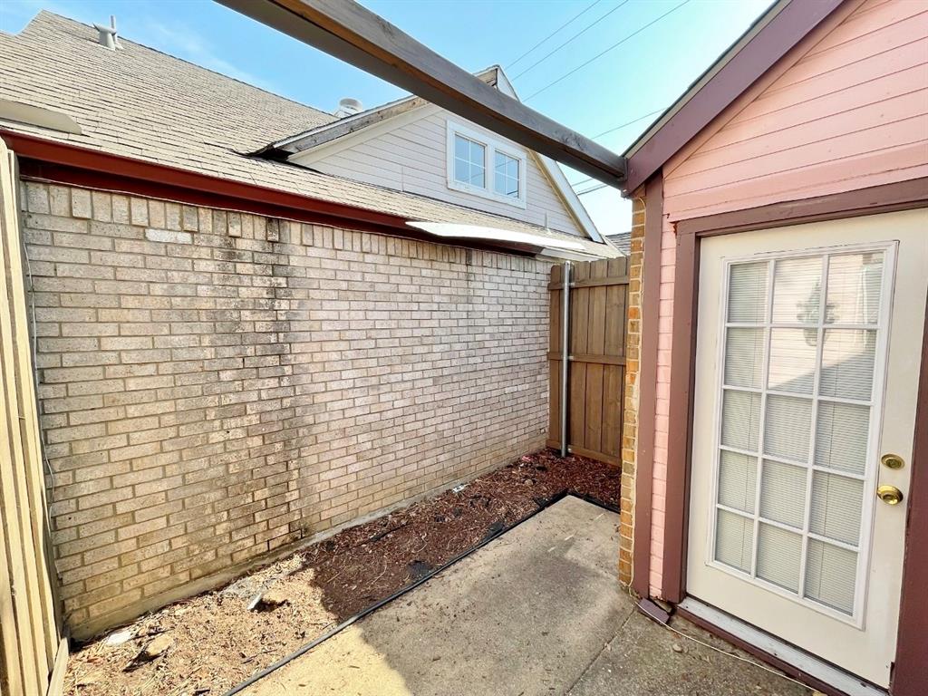 3147 Royal Gable Drive Dallas, TX 75229 - Photo 21 of 22 a view of a brick house with a large window