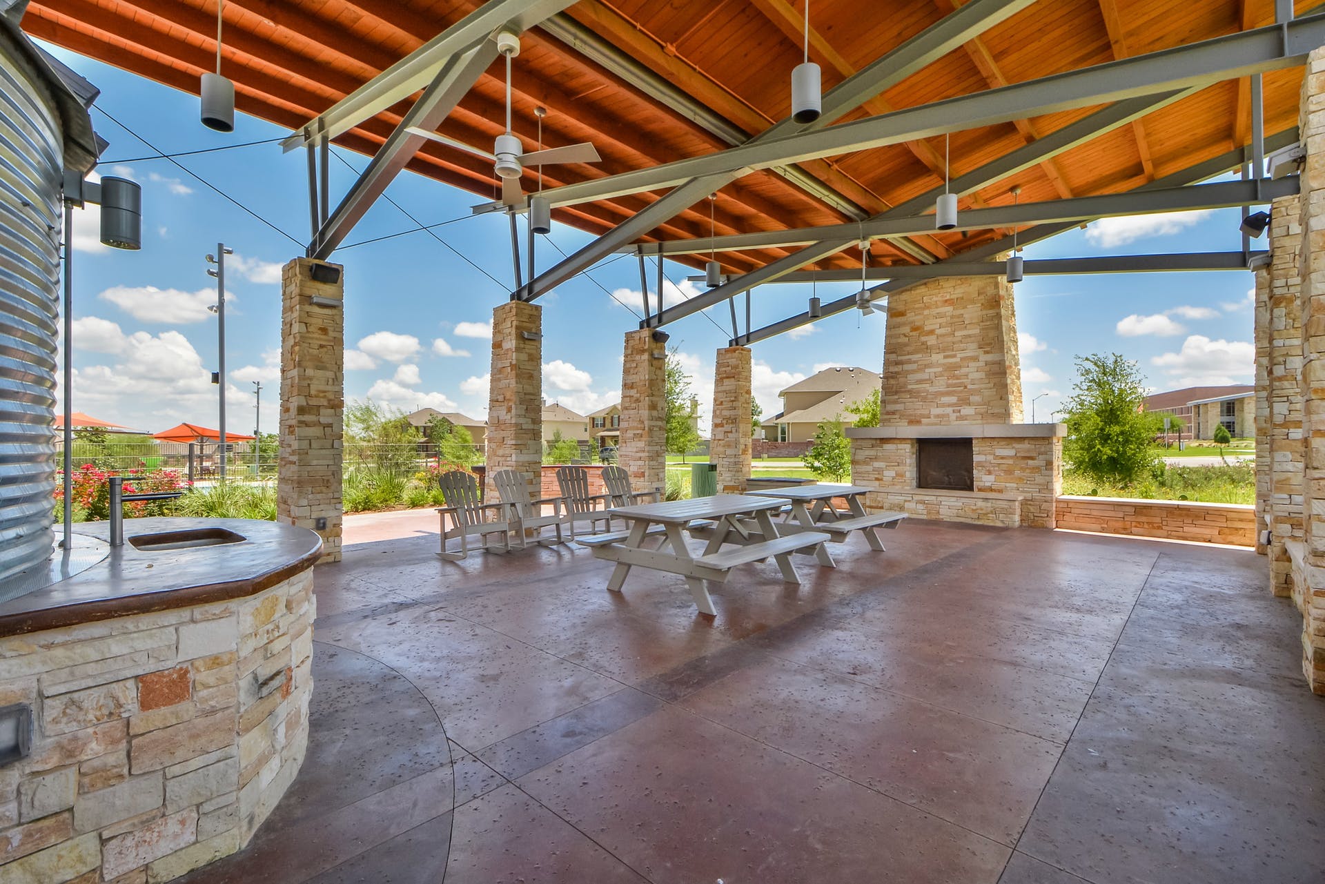 2004 Autumn Run Lane Round Rock, TX 78665 - Photo 30 of 37 An inviting community pavilion features a large covered patio with a built-in fireplace and outdoor kitchen, perfect for gatherings.