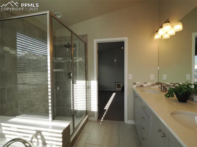 a spacious bathroom with a shower and a sink