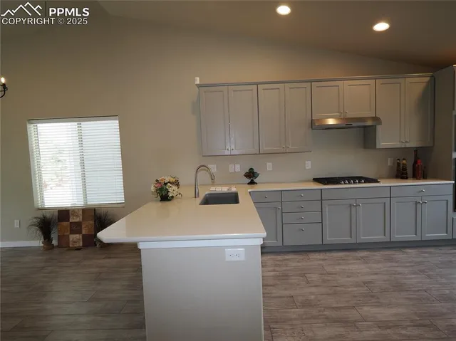 a kitchen with a sink and cabinets