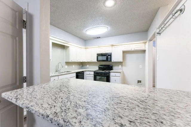 a stove top oven sitting inside of a kitchen