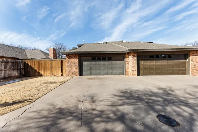a view of an empty room with window and fire place