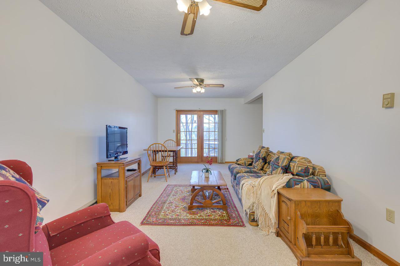 1524 Lamplight Road Bunker Hill, WV 25413 - Photo 22 of 44 a bed room with furniture and a chandelier