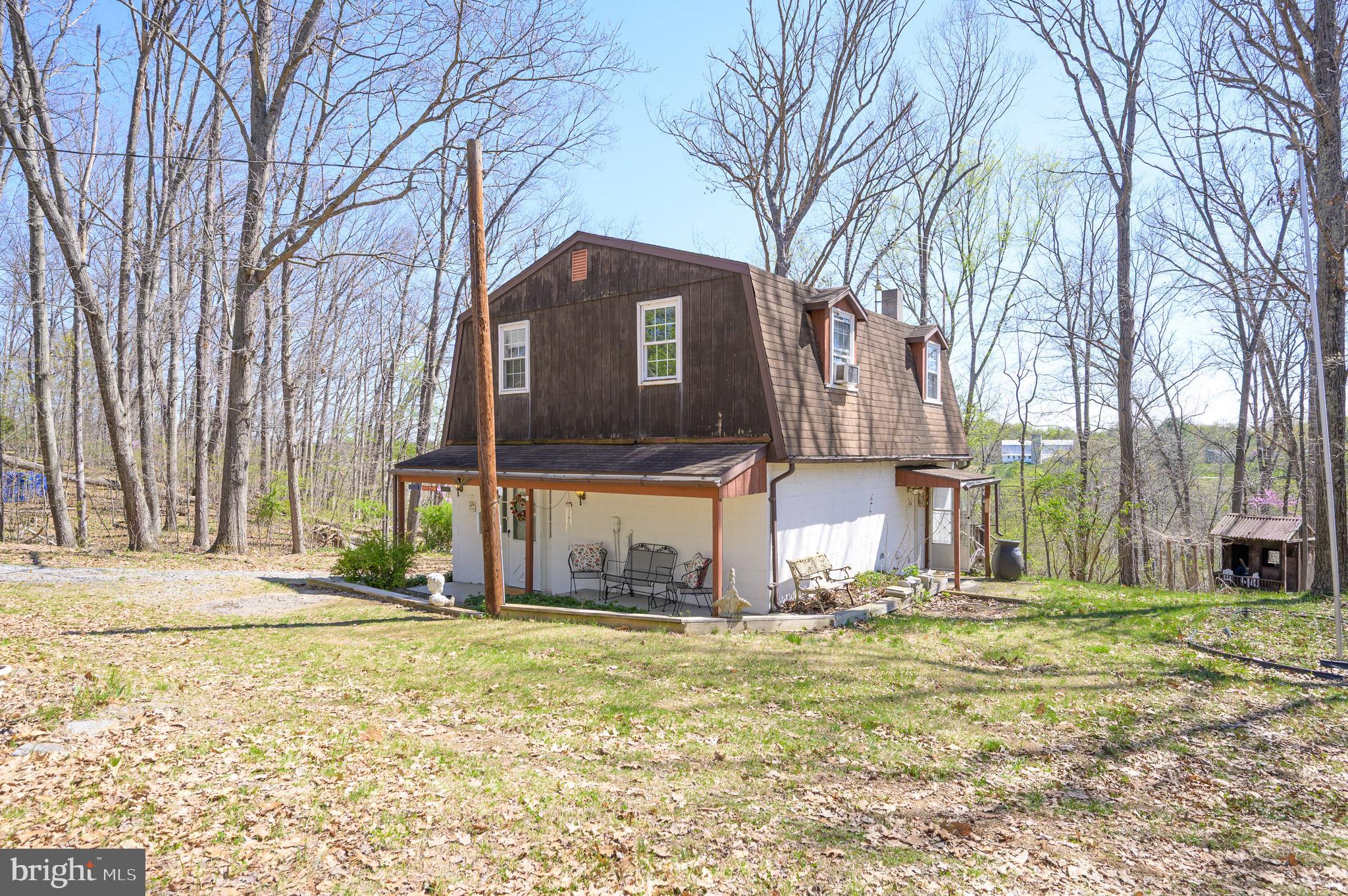 1524 Lamplight Road Bunker Hill, WV 25413 - Photo 3 of 44 a front view of a house with a yard
