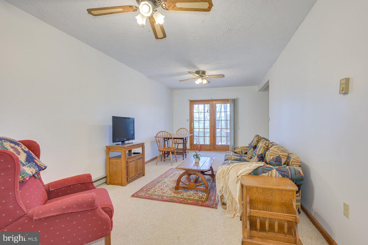 1524 Lamplight Road Bunker Hill, WV 25413 - Photo 6 of 44 a living room with furniture and a chandelier
