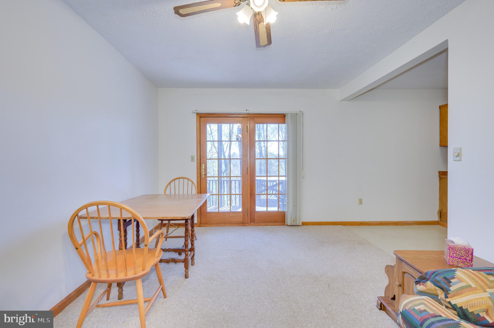 1524 Lamplight Road Bunker Hill, WV 25413 - Photo 7 of 44 a view of a room with a table and chairs