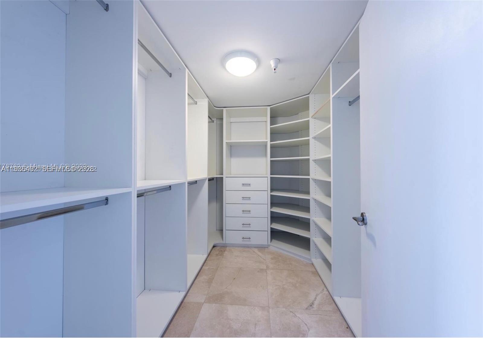 9401 Collins Avenue, Unit 206 Surfside, FL 33154 - Photo 15 of 21 a view of walk in closet with empty racks