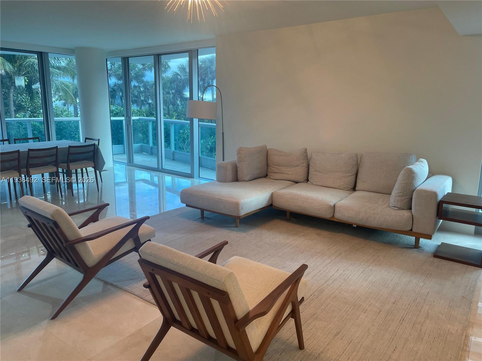 9401 Collins Avenue, Unit 206 Surfside, FL 33154 - Photo 4 of 21 a living room with furniture and a window