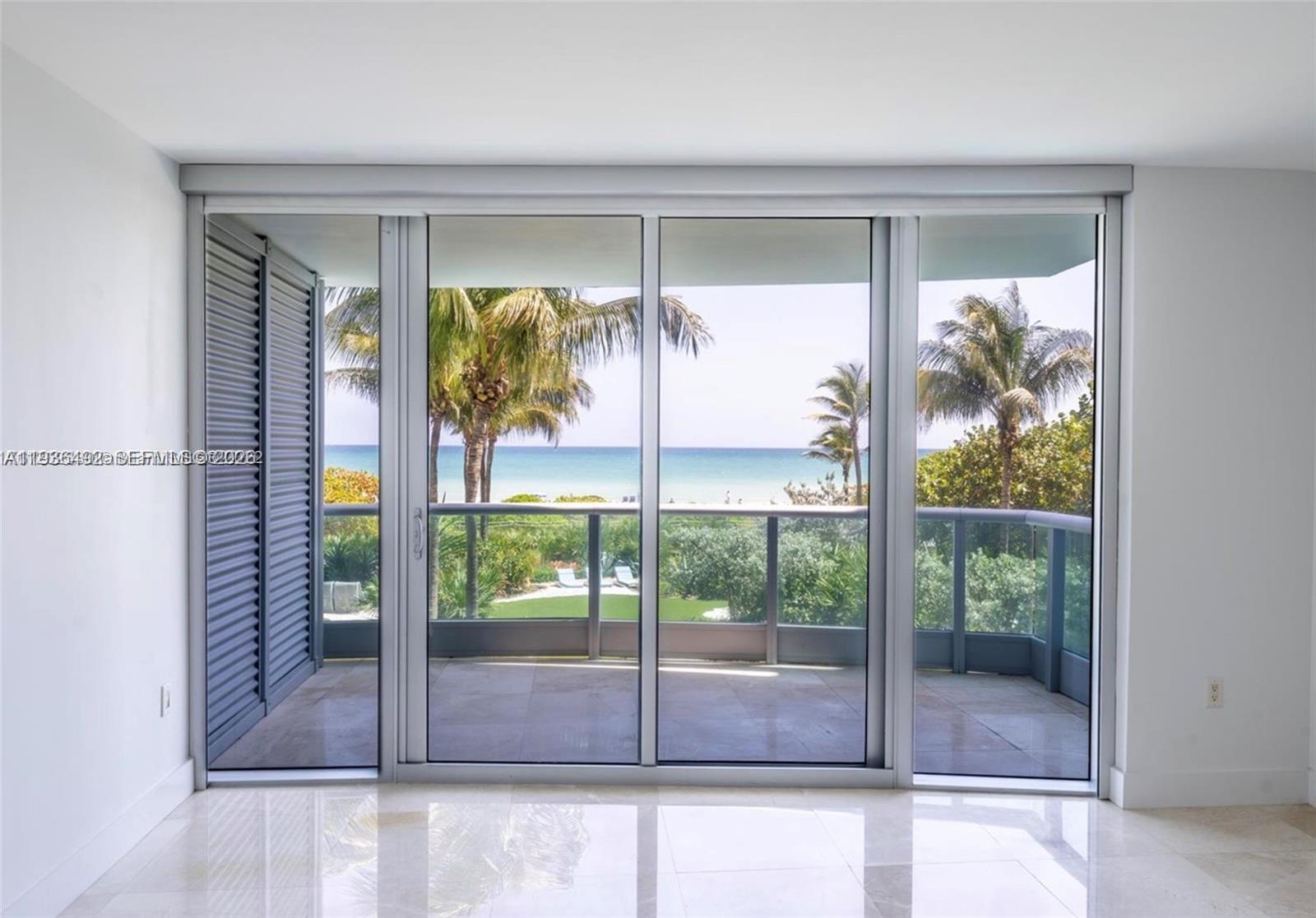 9401 Collins Avenue, Unit 206 Surfside, FL 33154 - Photo 6 of 21 a view of a glass door of the house