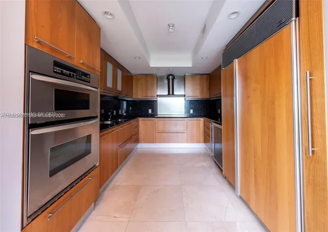 a kitchen with stainless steel appliances a stove and a microwave