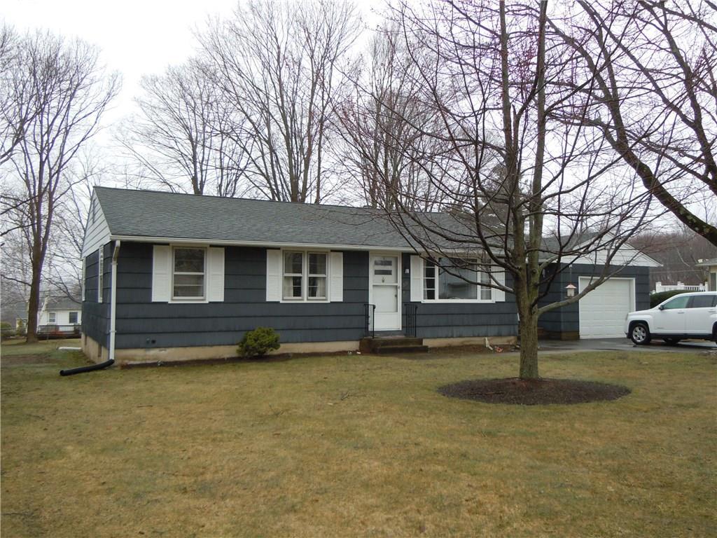 a view of a house with a yard and large trees